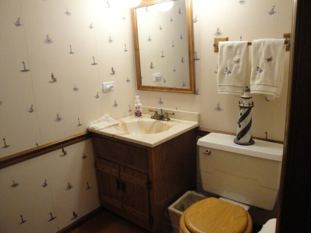 bathroom with toilet and large vanity