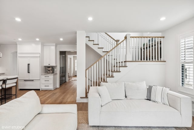 living room featuring a healthy amount of sunlight and light hardwood / wood-style floors