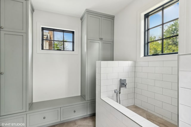 bathroom with a healthy amount of sunlight and tile flooring