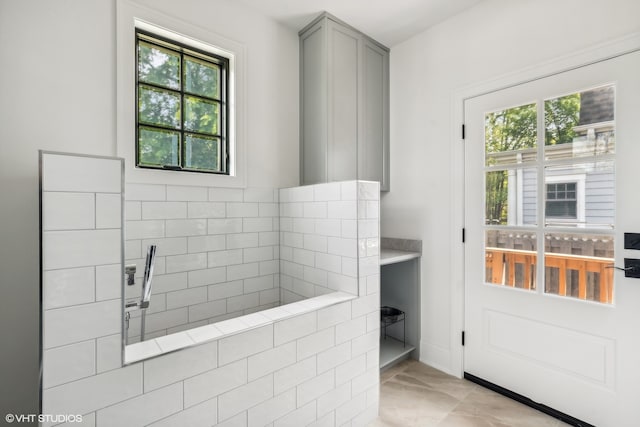 bathroom featuring plenty of natural light and tile floors