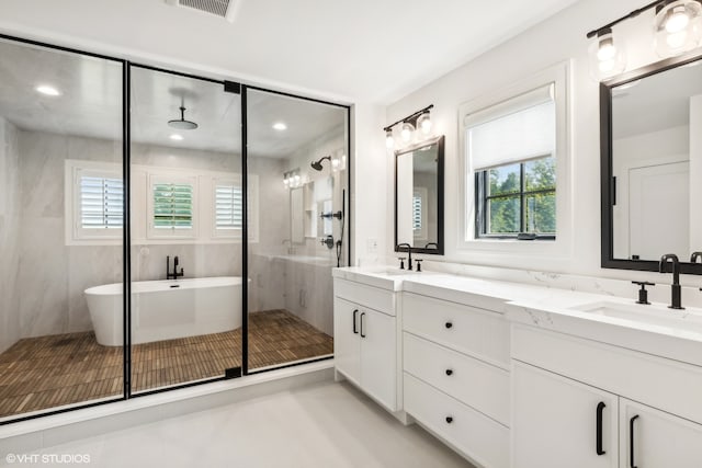 bathroom featuring a wealth of natural light, double sink vanity, tile floors, and shower with separate bathtub