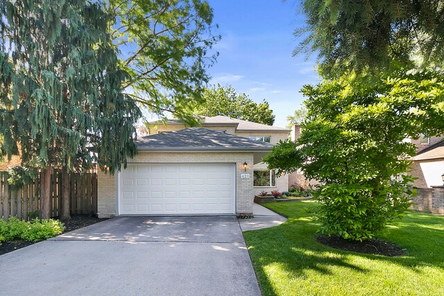 view of front of property with a front lawn and a garage