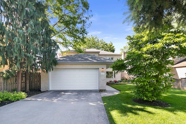 view of front facade with brick siding, concrete driveway, an attached garage, a front yard, and fence