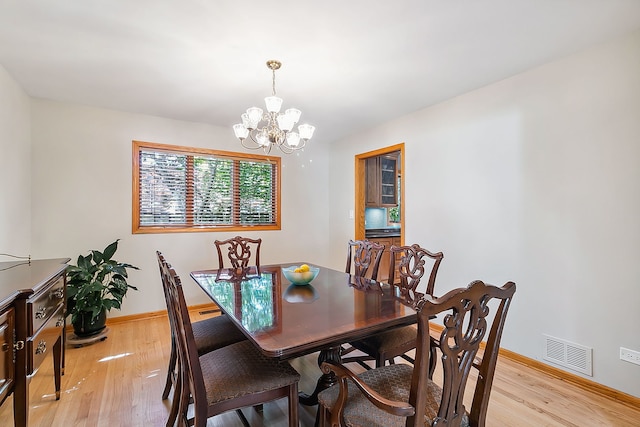 dining area with baseboards, visible vents, and light wood-style flooring