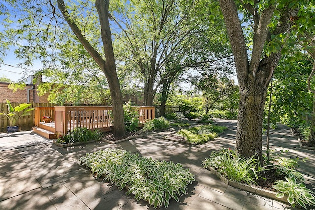 surrounding community with fence and a deck