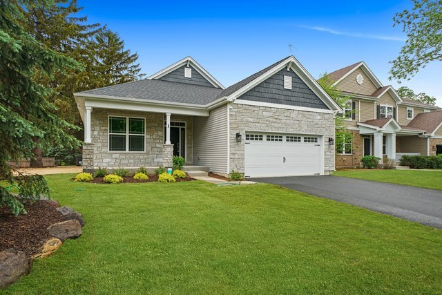 craftsman inspired home featuring a front yard and a garage