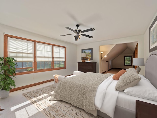 bedroom with light carpet, multiple windows, and ceiling fan