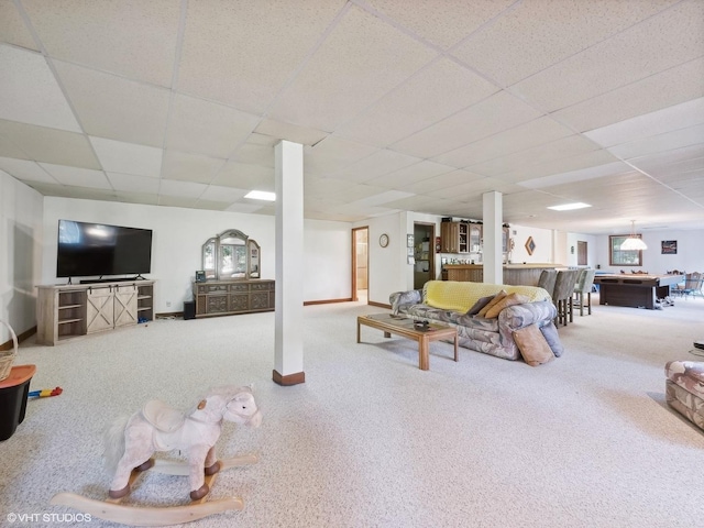 living room with carpet floors and a paneled ceiling