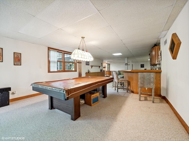 recreation room with a drop ceiling, pool table, and bar area