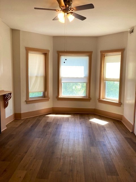 unfurnished room with ceiling fan and dark hardwood / wood-style flooring