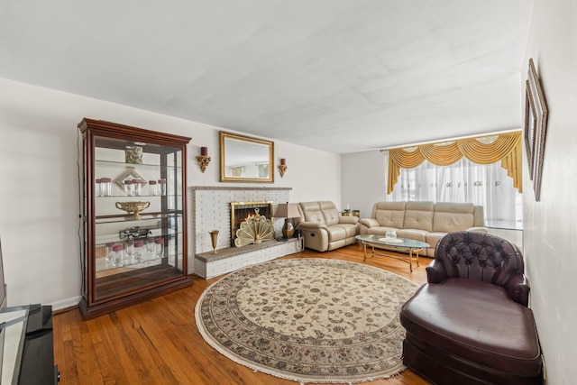 living room featuring hardwood / wood-style flooring and a fireplace