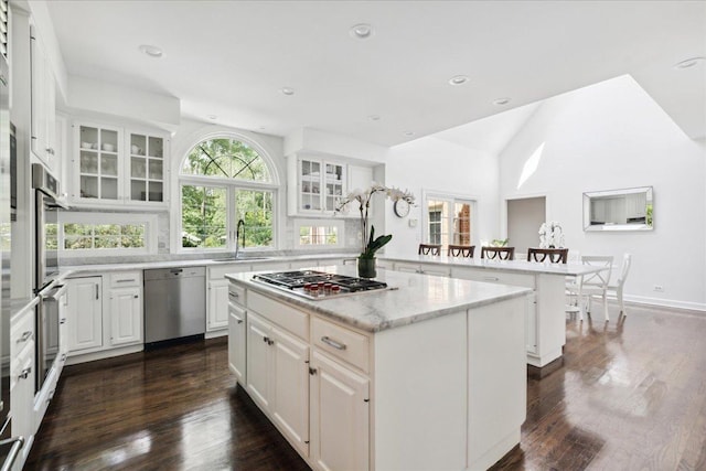 kitchen with white cabinetry, a center island, and appliances with stainless steel finishes