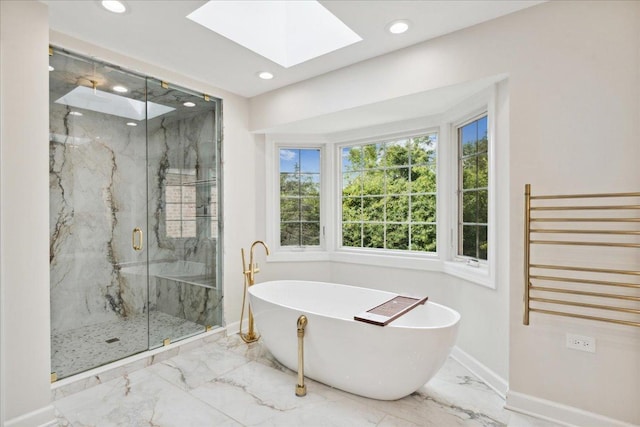 bathroom with a skylight, radiator heating unit, and separate shower and tub