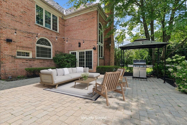 view of patio / terrace featuring an outdoor living space, a gazebo, and grilling area