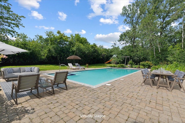 view of pool featuring an outdoor living space, a playground, and a patio