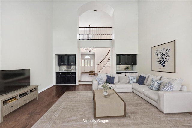 living room with hardwood / wood-style flooring and a high ceiling