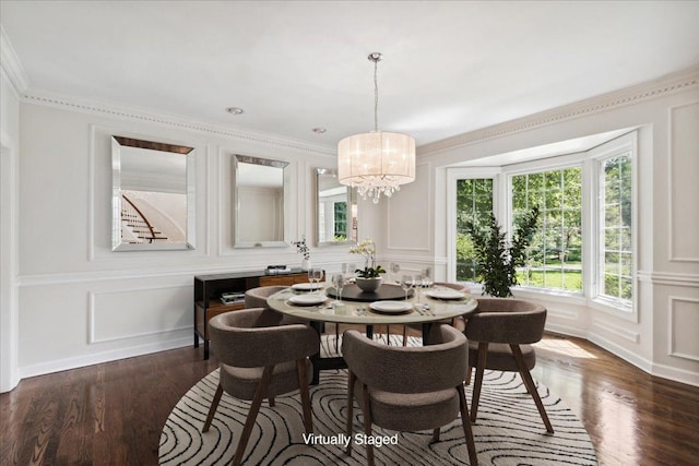 dining area featuring dark hardwood / wood-style flooring, ornamental molding, and a chandelier