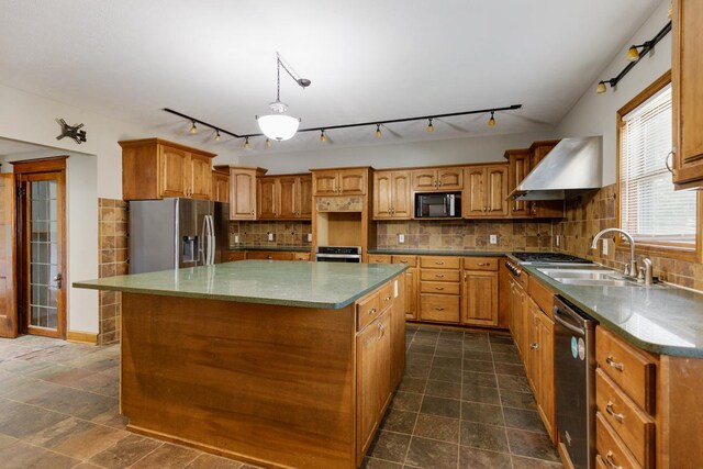 kitchen featuring decorative backsplash, a center island, appliances with stainless steel finishes, and dark tile patterned floors