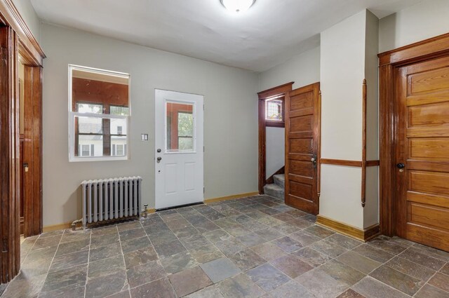 entryway featuring radiator and dark tile patterned flooring