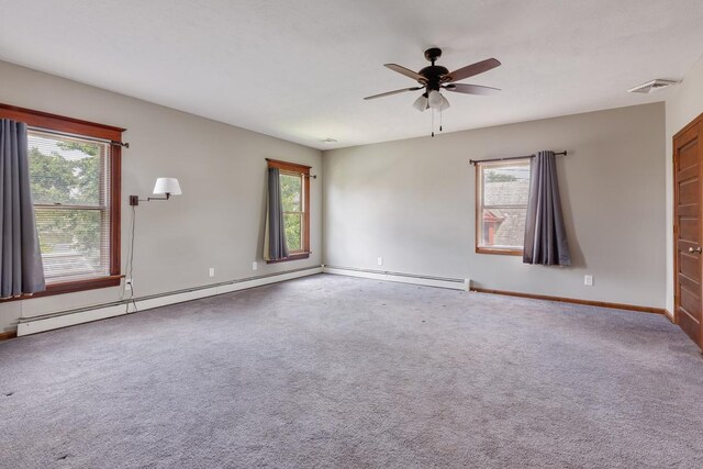 carpeted empty room featuring ceiling fan and a baseboard heating unit