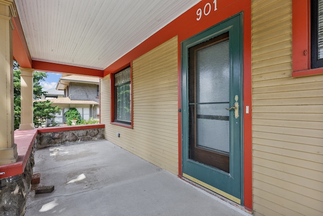 view of exterior entry featuring a porch