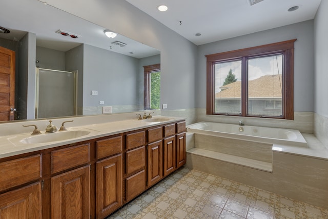 bathroom with shower with separate bathtub, tile patterned floors, and double sink vanity