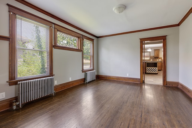 unfurnished room with radiator heating unit and wood-type flooring