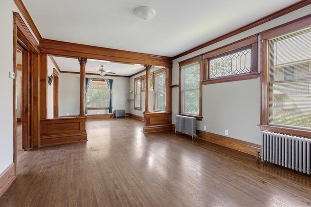 interior space with radiator heating unit, ceiling fan, and dark hardwood / wood-style flooring