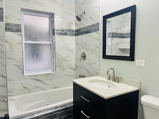 full bathroom with vanity, toilet, and tiled shower / bath