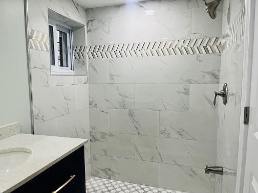 bathroom featuring vanity and a tile shower