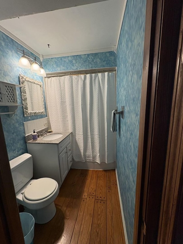 bathroom with vanity, crown molding, walk in shower, and hardwood / wood-style floors