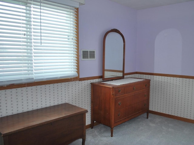 carpeted bedroom featuring multiple windows