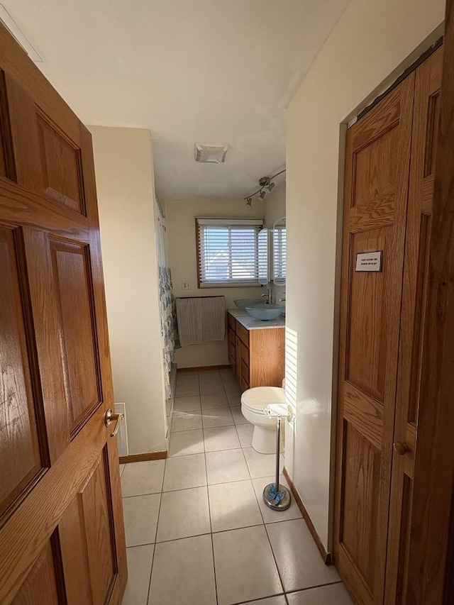 bathroom with tile patterned floors, toilet, and vanity