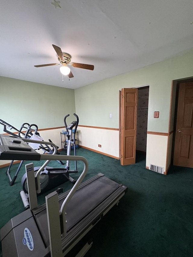 workout area with dark carpet and ceiling fan