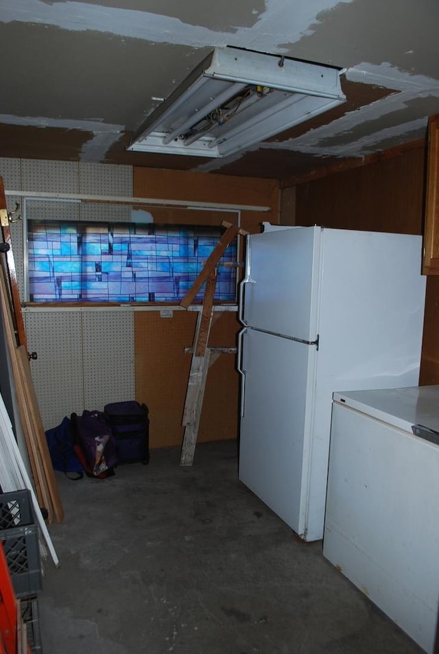 basement featuring white fridge