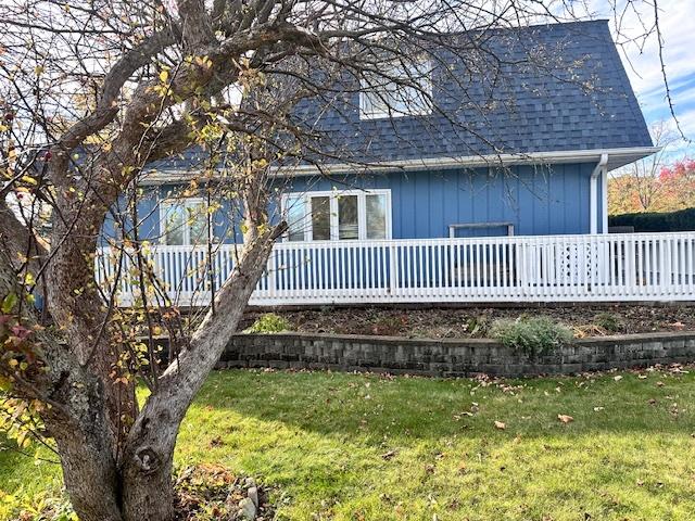 back of house featuring a yard and a deck