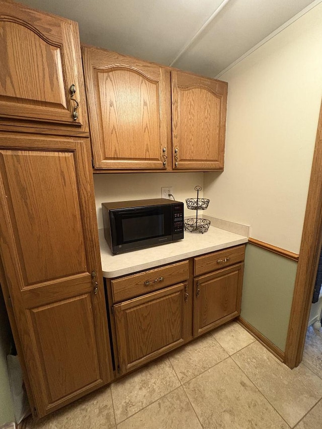 kitchen with light tile patterned flooring