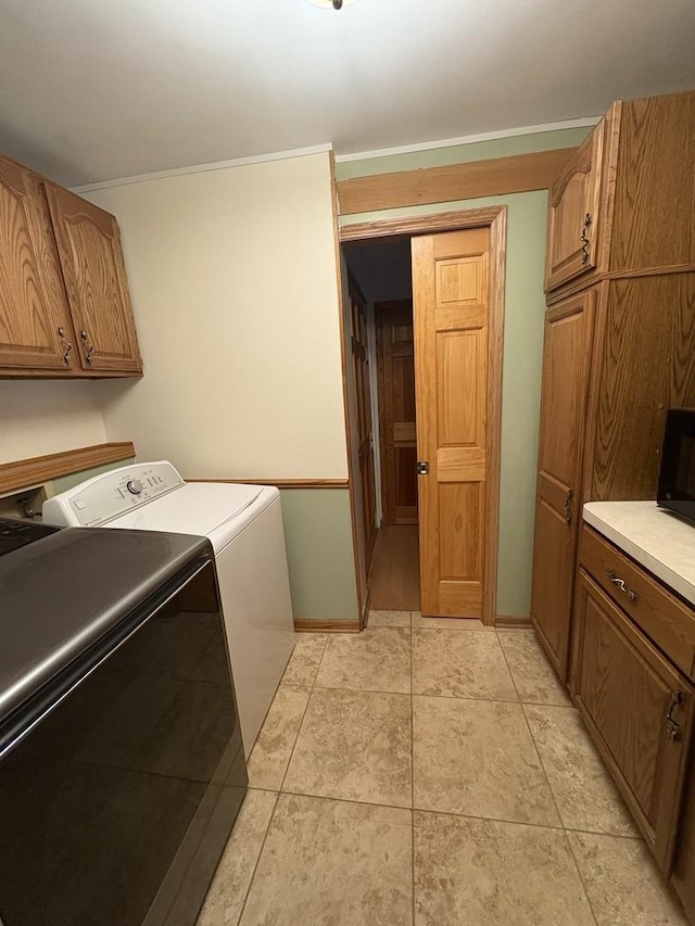 laundry room with cabinets and washing machine and clothes dryer