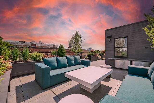 patio terrace at dusk featuring an outdoor hangout area