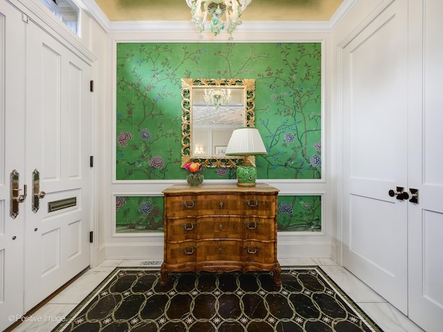 foyer featuring tile floors and ornamental molding