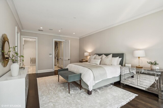 bedroom with dark hardwood / wood-style floors and crown molding