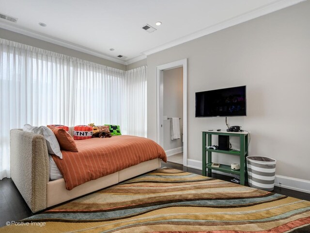 bedroom featuring ornamental molding and dark wood-type flooring