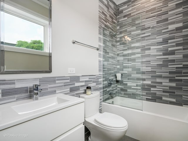 full bathroom with tile walls, enclosed tub / shower combo, tasteful backsplash, vanity, and toilet