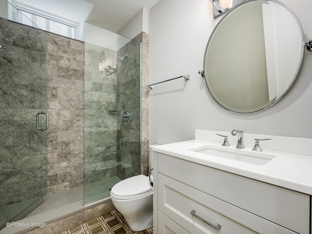 bathroom featuring tile flooring, an enclosed shower, vanity, and toilet