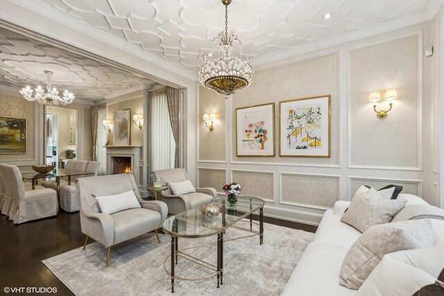 living room featuring a notable chandelier, hardwood / wood-style floors, and ornamental molding