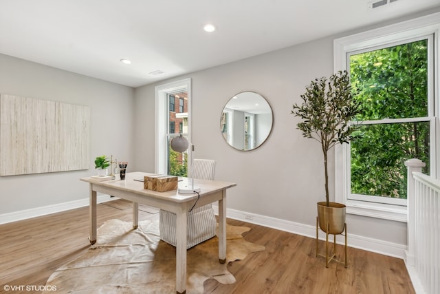 home office with hardwood / wood-style flooring