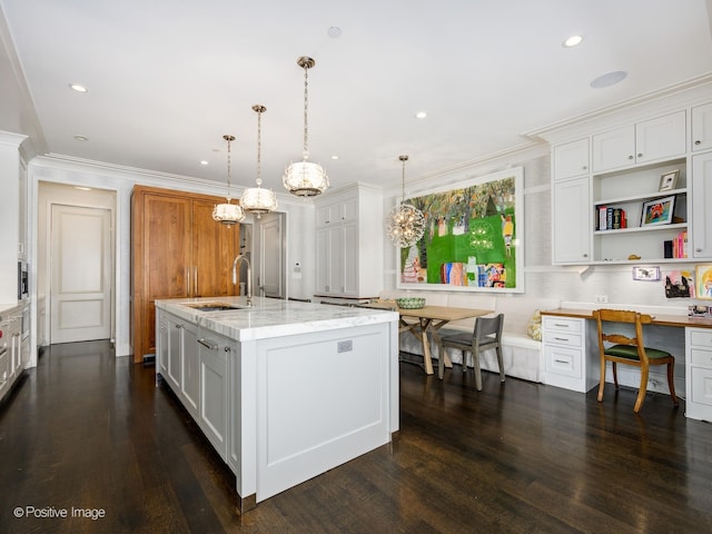 kitchen featuring hanging light fixtures, white cabinetry, sink, and dark hardwood / wood-style floors