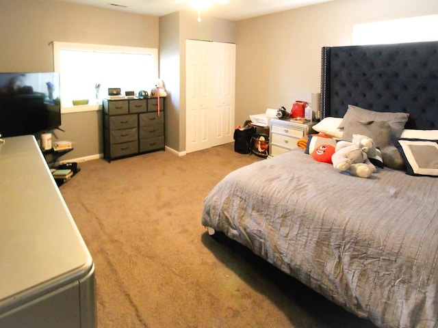 bedroom with light colored carpet and a closet