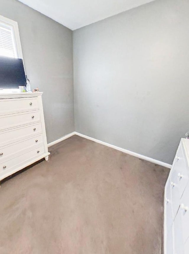 unfurnished bedroom featuring dark carpet