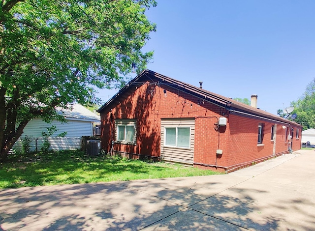 view of home's exterior featuring a yard and cooling unit